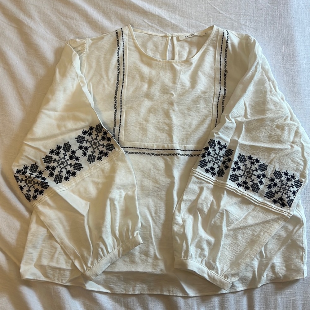 NWT Trendy blouse with black detail. Size Large. Fits like a medium. Never worn.